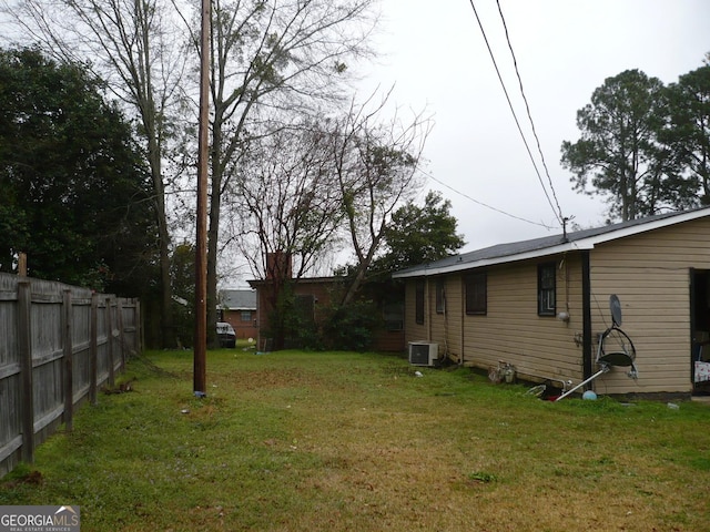 view of yard with cooling unit and fence