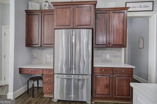 kitchen featuring light countertops, dark wood finished floors, freestanding refrigerator, and baseboards