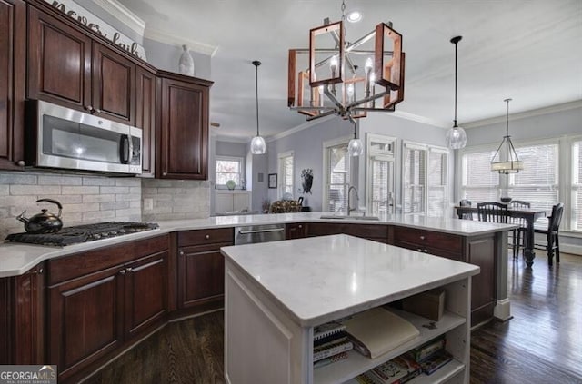 kitchen featuring open shelves, appliances with stainless steel finishes, a sink, and light countertops