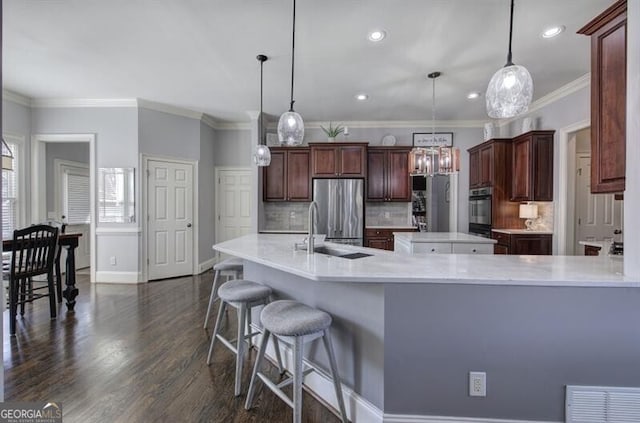 kitchen with a sink, visible vents, light countertops, freestanding refrigerator, and dark wood-style floors