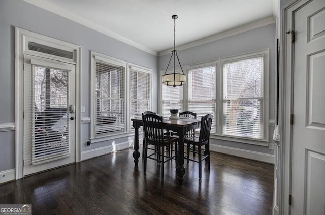 dining room with baseboards, dark wood-style flooring, and crown molding