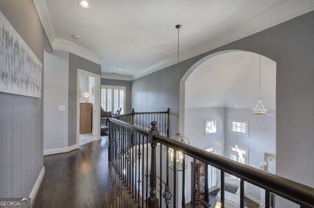 hallway featuring recessed lighting, ornamental molding, an upstairs landing, wood finished floors, and baseboards