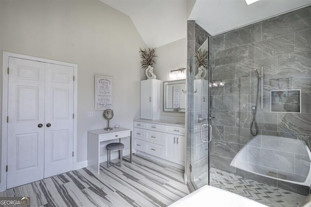 full bathroom with lofted ceiling, a shower stall, and vanity