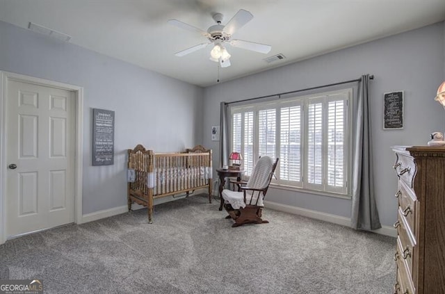 carpeted bedroom with ceiling fan, visible vents, and baseboards