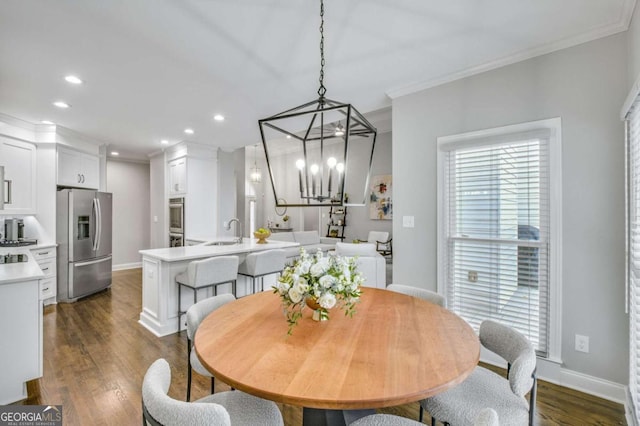 dining space featuring baseboards, recessed lighting, dark wood finished floors, and crown molding