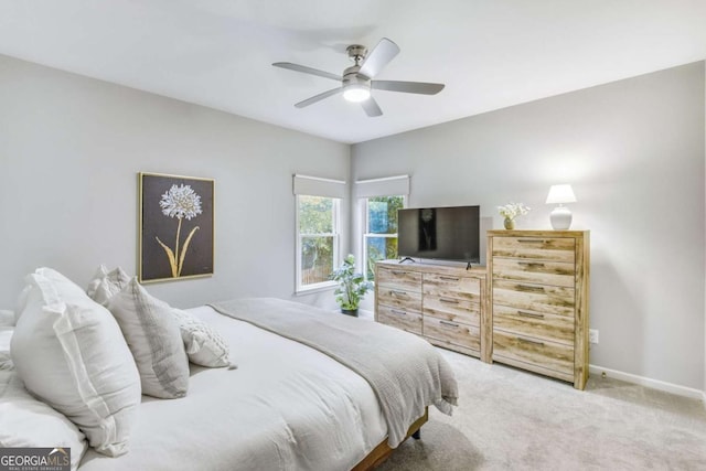 carpeted bedroom featuring ceiling fan and baseboards