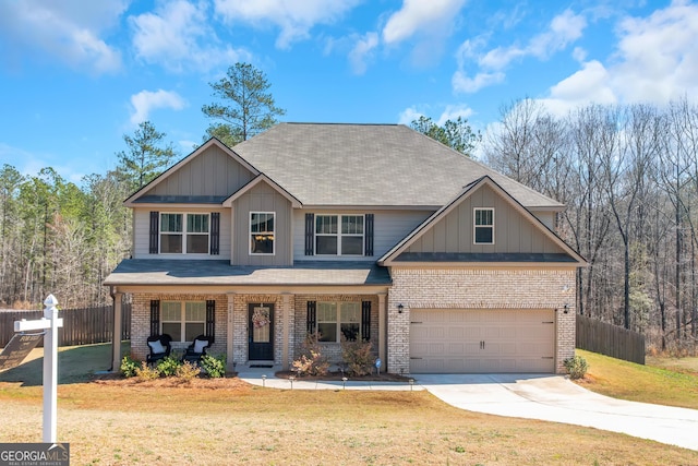 craftsman house with brick siding, a front lawn, and fence