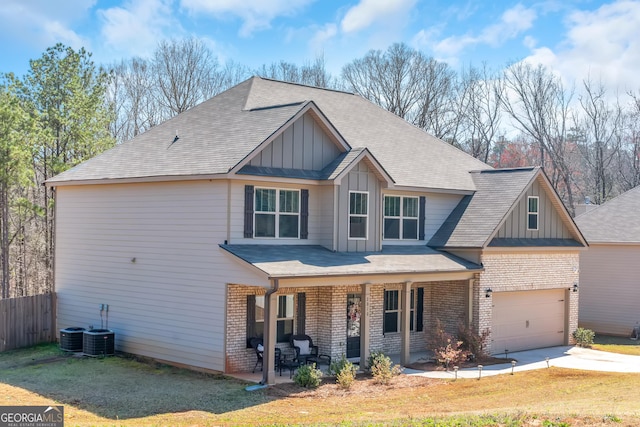 view of front of property with brick siding, board and batten siding, and fence