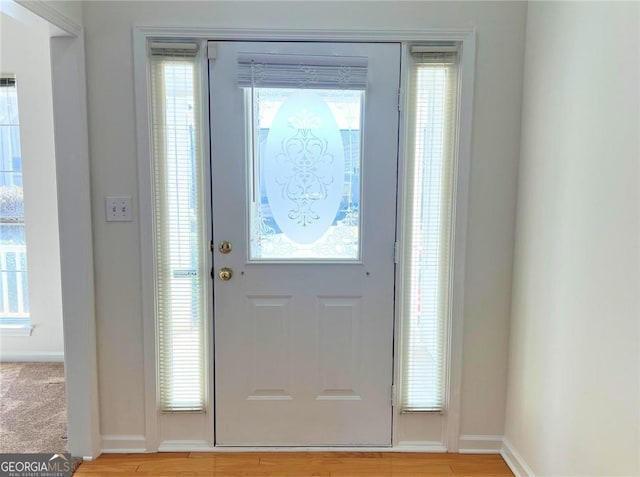 entryway featuring light wood-type flooring and baseboards