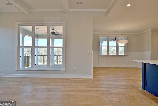 unfurnished living room featuring light wood finished floors, visible vents, and beamed ceiling