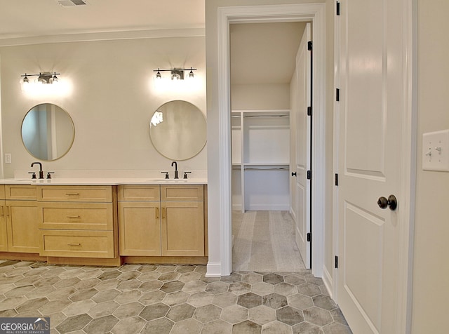 bathroom with double vanity, a sink, and visible vents