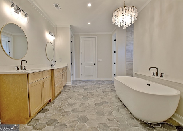 bathroom featuring double vanity, a freestanding tub, crown molding, and a sink
