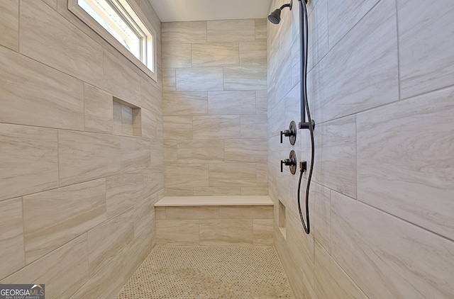 bathroom featuring a tile shower