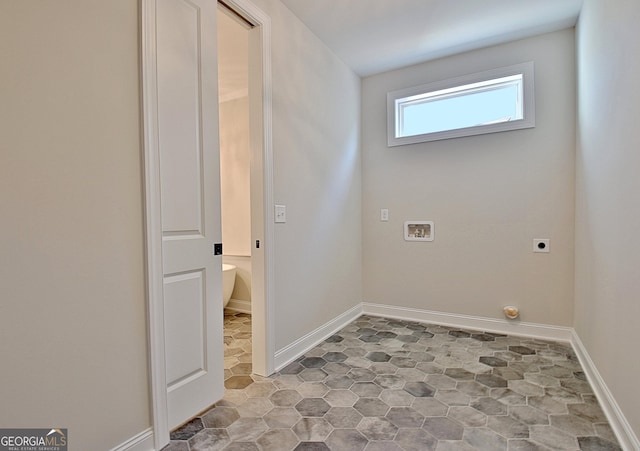 clothes washing area with baseboards, hookup for a washing machine, and hookup for an electric dryer