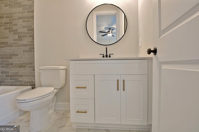bathroom featuring baseboards, toilet, marble finish floor, vanity, and a bath