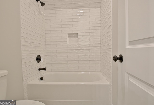 bathroom featuring shower / bath combination and toilet