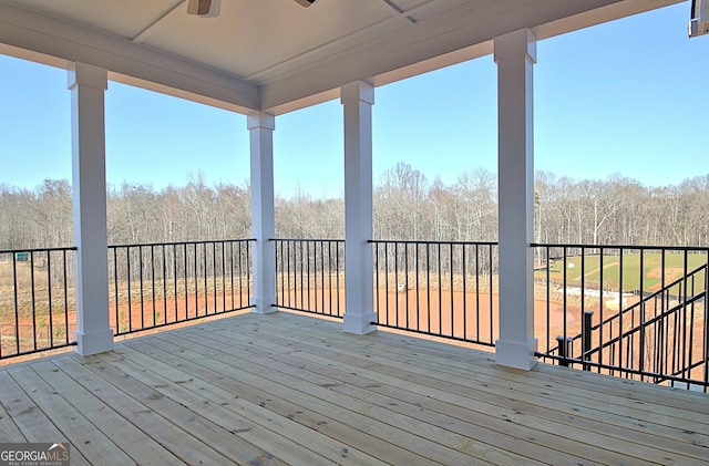 wooden deck with a ceiling fan