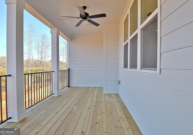 wooden terrace featuring ceiling fan