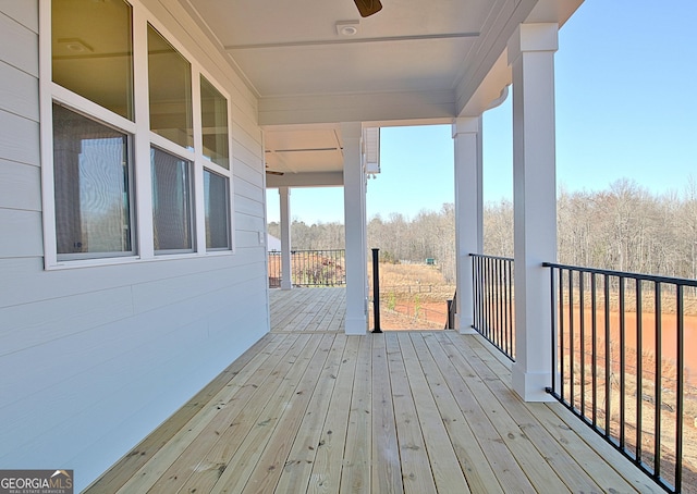 wooden deck with a ceiling fan