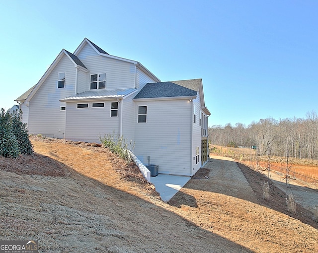 view of side of property featuring central AC unit