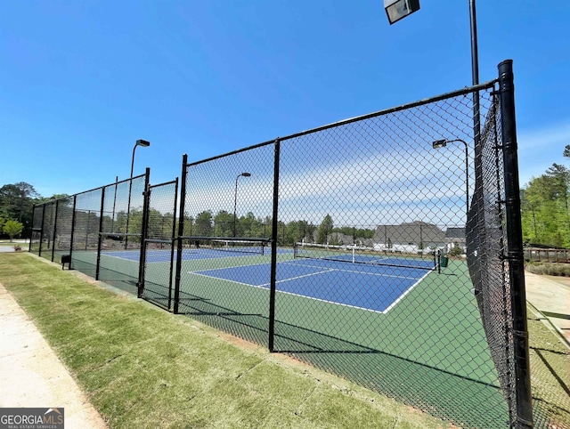 view of tennis court with fence
