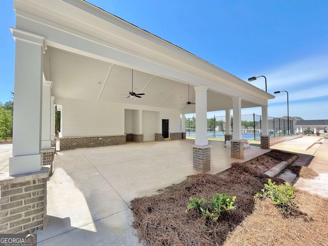 view of patio / terrace with ceiling fan and fence