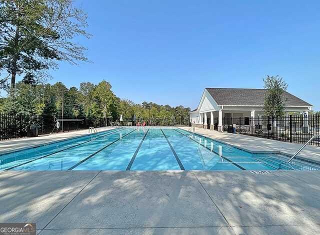 view of pool featuring fence