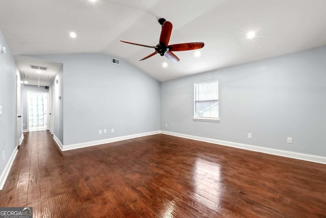 unfurnished living room featuring lofted ceiling, dark wood finished floors, and baseboards