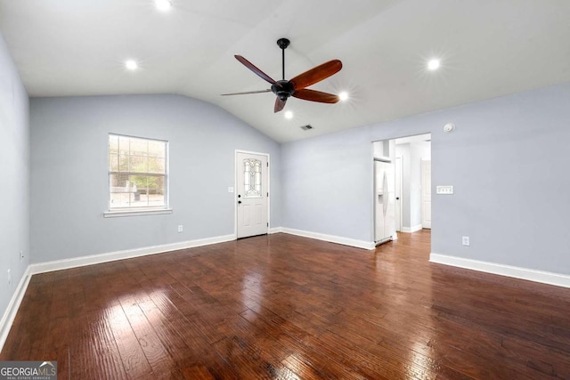 unfurnished living room with baseboards, visible vents, a ceiling fan, dark wood-style floors, and vaulted ceiling