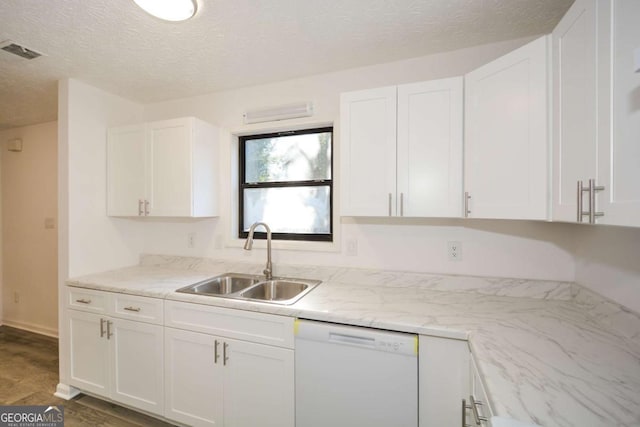 kitchen featuring dishwasher, a sink, and white cabinetry