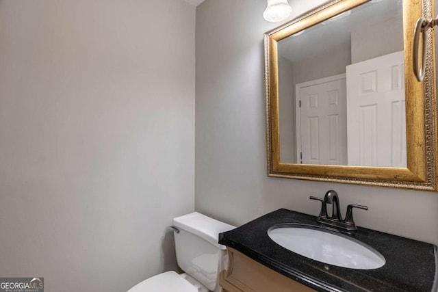 half bath featuring toilet and vanity