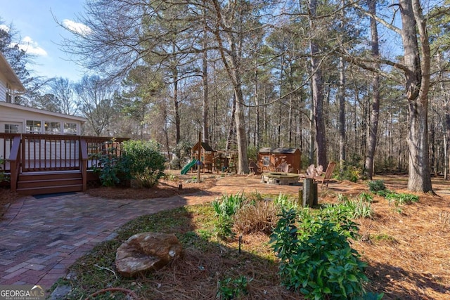 view of yard with a playground and a wooden deck