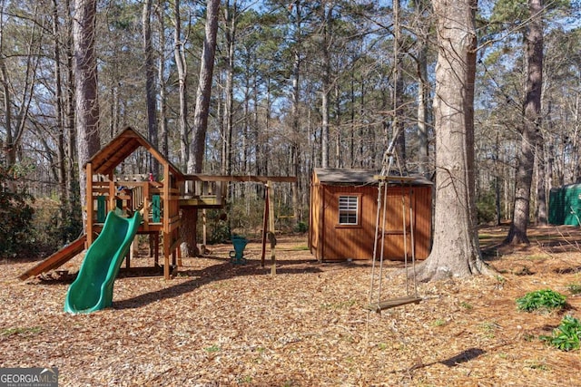 view of playground featuring a storage shed and an outbuilding