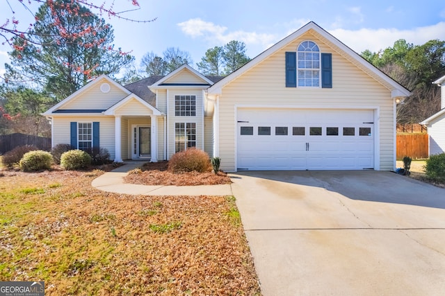 traditional-style house with driveway and fence