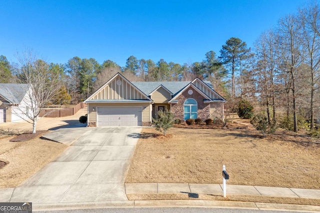 view of front facade featuring driveway, board and batten siding, an attached garage, and fence