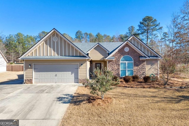 view of front of home with board and batten siding, concrete driveway, stone siding, and a garage