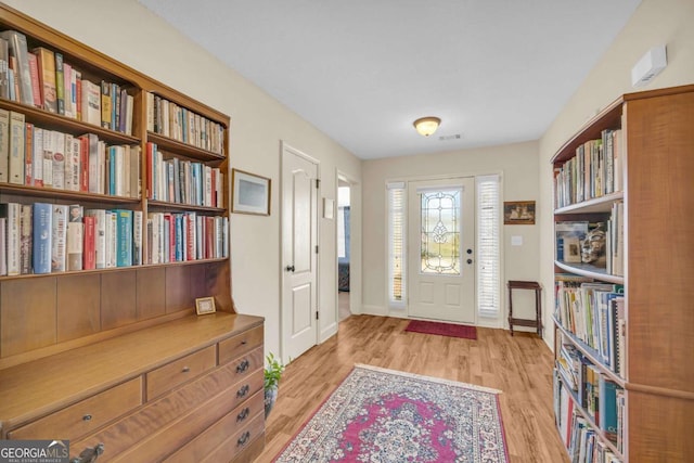 entrance foyer featuring baseboards, visible vents, and light wood finished floors