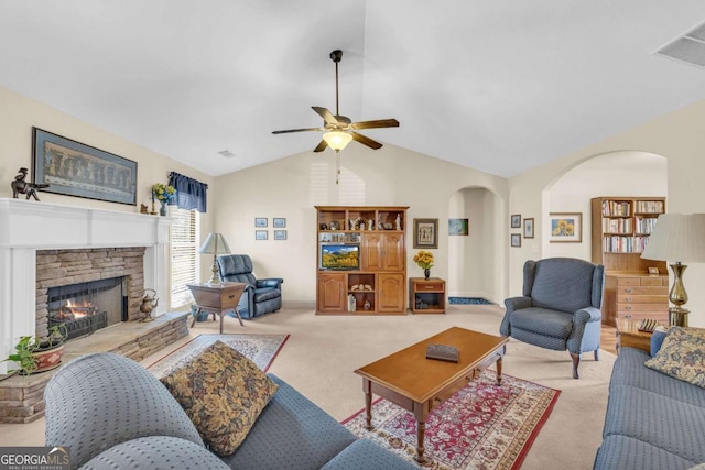 living room with arched walkways, light colored carpet, a fireplace, visible vents, and vaulted ceiling