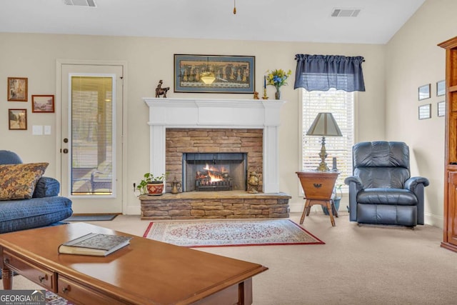 living room with light carpet, a fireplace, and visible vents