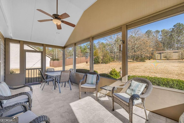 sunroom with plenty of natural light, vaulted ceiling, and a ceiling fan