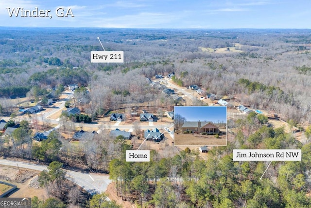 birds eye view of property featuring a wooded view