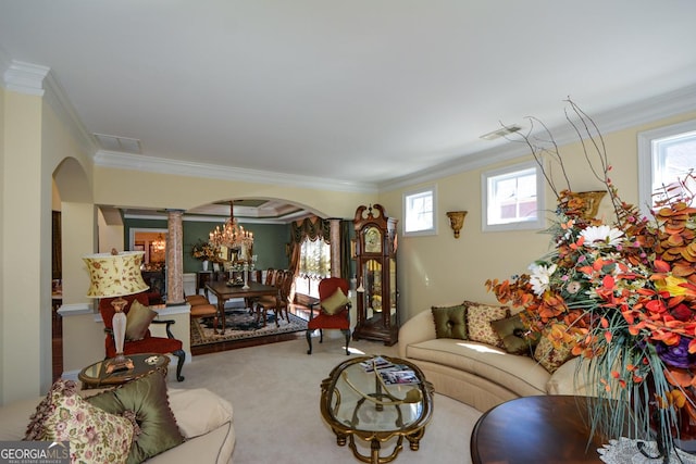 carpeted living area with ornamental molding, arched walkways, visible vents, and ornate columns