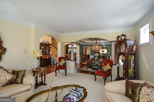 carpeted living room featuring ornamental molding, arched walkways, ornate columns, and stairs