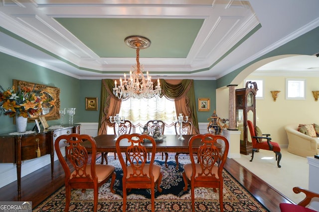 dining area featuring ornamental molding, arched walkways, wainscoting, and decorative columns