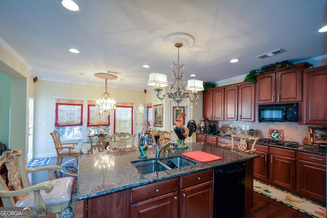 kitchen featuring visible vents, decorative light fixtures, a sink, black appliances, and a notable chandelier