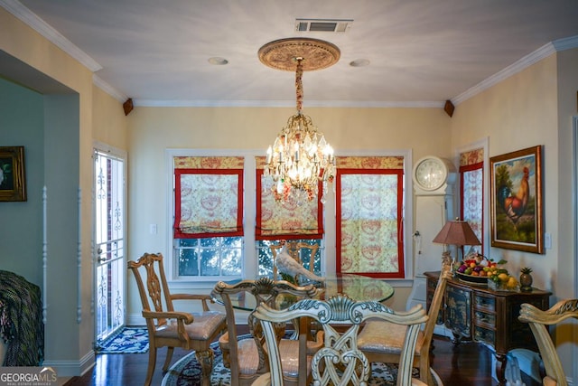 dining space featuring crown molding, dark wood finished floors, a notable chandelier, visible vents, and baseboards