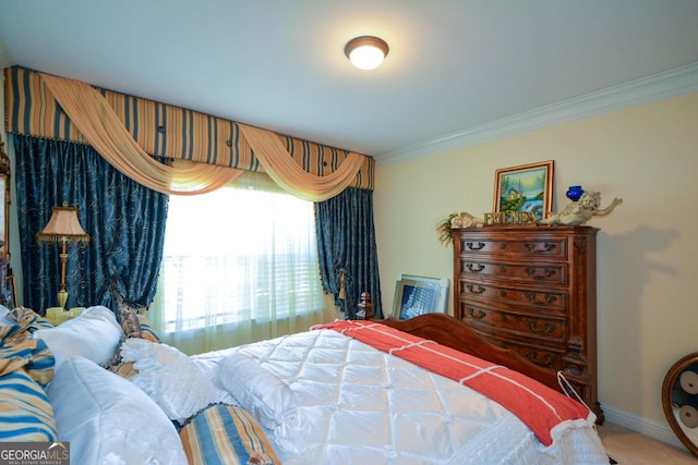 bedroom featuring baseboards, crown molding, and carpet flooring