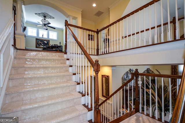 staircase with recessed lighting, visible vents, a ceiling fan, ornamental molding, and decorative columns