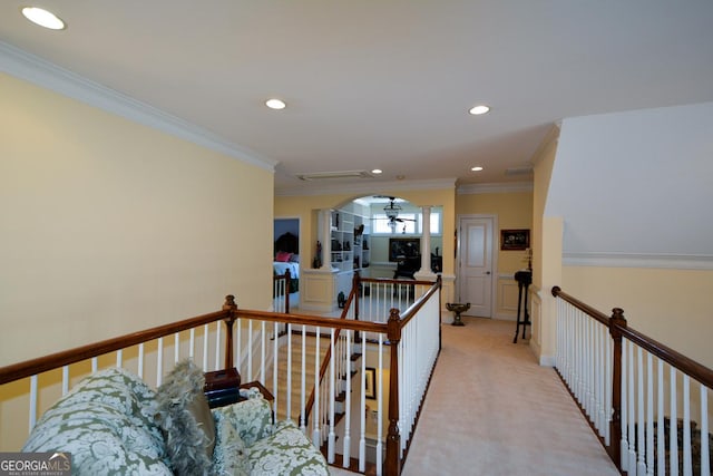 hallway with ornamental molding, recessed lighting, light colored carpet, and an upstairs landing