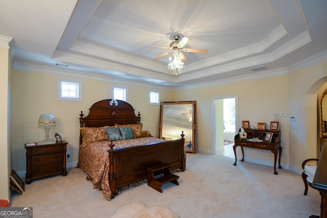 bedroom with arched walkways, light carpet, baseboards, a raised ceiling, and crown molding